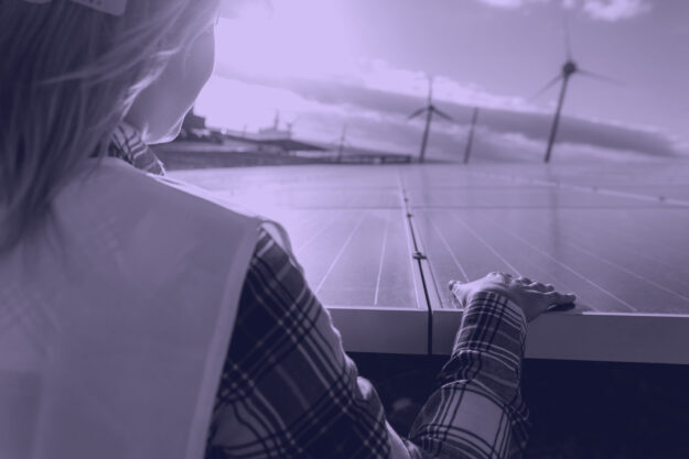 Young female engineer working for alternative energy with wind t