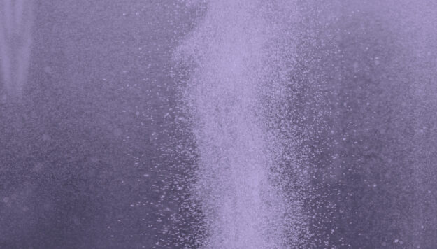 Column of hydrogen bubbles in water against blue background