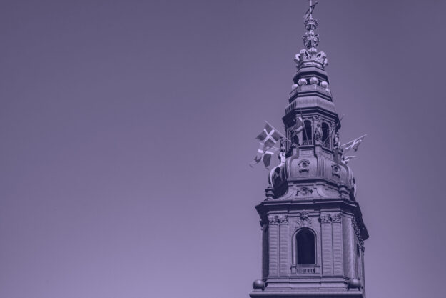 Urban scene with historical Christiansborg Palace against clear